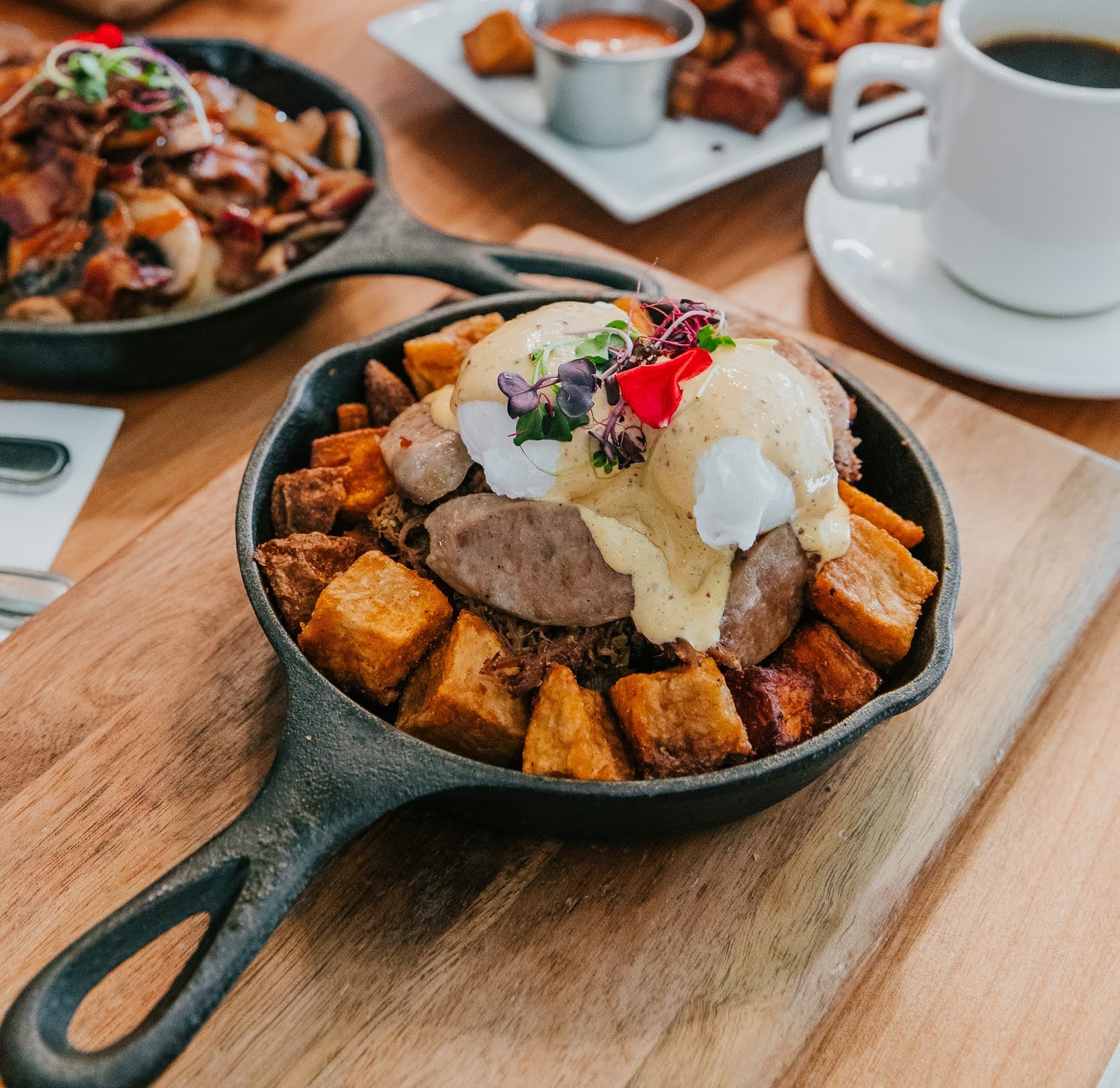 Monki brisket hash with brisket soft poached eggs sausage and hashbrown